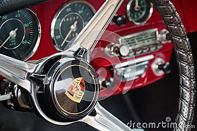 TORONTO, CANADA - 08 18 2018: Steering wheel with logo on horn button, dials and knobs on front panel of 1965 Porsche 356C Ruby Re Editorial Stock Photo