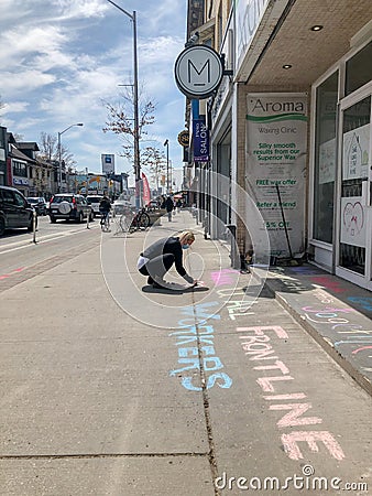 TORONTO, ONTARIO, CANADA - APRIL 28, 2020: PERSON WRITES POSITIVE MESSAGE IN CHALK ON SIDEWALK DURING COVID-19 PANDEMIC. Editorial Stock Photo