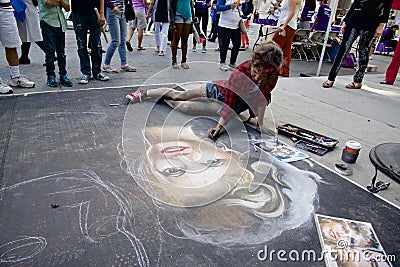 Female artists painting with chalk and pastels on the street of Toronto Editorial Stock Photo