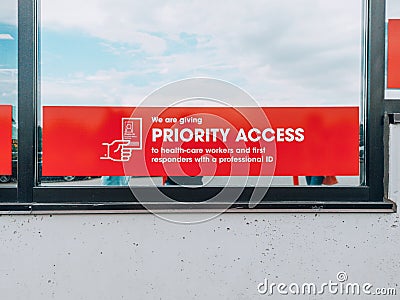 Toronto, Ontario, Canada - August 16, 2020: Warning notice sign on store market window to priority access to health care frontline Editorial Stock Photo