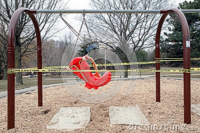 Toronto, Ontario, Canada - March 26, 2020: A closed outdoor playground. Kids play area locked with yellow caution tape to stop Editorial Stock Photo