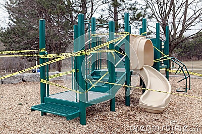 Toronto, Ontario, Canada - March 26, 2020: A closed outdoor playground. Kids play area locked with yellow caution tape to stop Editorial Stock Photo