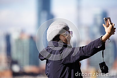 Tourist taking selfies in Toronto Lake. Editorial Stock Photo