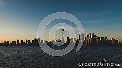 Toronto skyline during sunset seen from toronto island with lake ontario infront Stock Photo