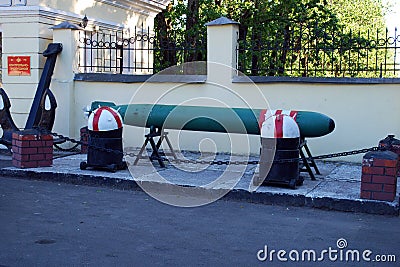 A torpedo, two floating mines and a huge anchor stand in front of the checkpoint of a military unit of the Russian Navy. Editorial Stock Photo