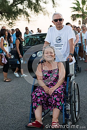 TORRE COLIMENA, ITALY - 1 August 2019, A disabled and elderly lady protests against being discharged to the sea Editorial Stock Photo