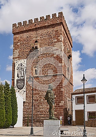 Torreon del Prior and Miguel de Cervantes statue at Alcazar de San Juan Editorial Stock Photo