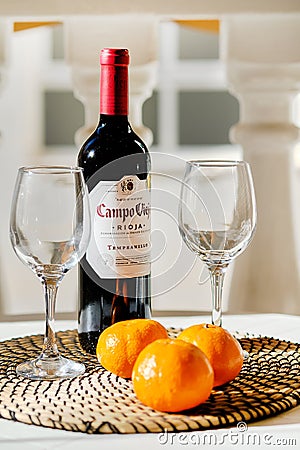 Torrevieja, Spain - April 11, 2019: Close up bottle Campo Viejo Rioja two empty clear wine glasses and three oranges Editorial Stock Photo
