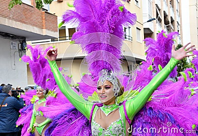 TORREVIEJA, SPAIN FEBRUARY 12, 2023: Participants dressed in a colorful carnival costumes on the street during the traditional Editorial Stock Photo