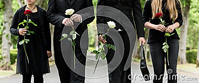 Torso of family on cemetery mourning Stock Photo