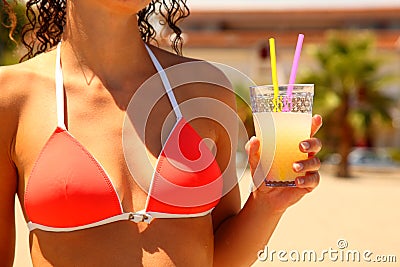 Torso of girl. She holds glass of juice Stock Photo