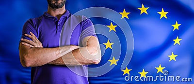 Torso of a man Young man with arms crossed against EU flag Stock Photo