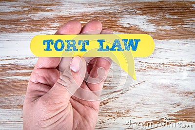 Tort Law. Yellow speech bubble in a man& x27;s hand Stock Photo