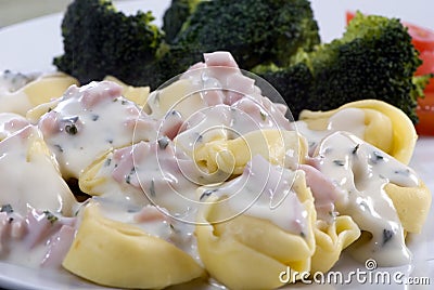 Tortellini with cream sauce Stock Photo