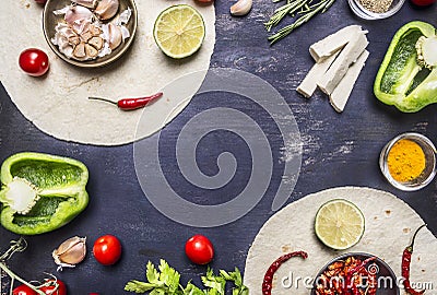 Tortilla with Ingredients for cooking vegetarian burrito with vegetables and lime on wooden rustic background top view close up w Stock Photo