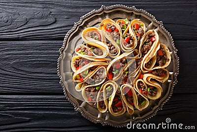 Tortilla stuffed with meat beef, peppers and onions closeup. Horizontal top view Stock Photo