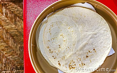 Tortillas in a bowl Plate on red table in Mexico Stock Photo
