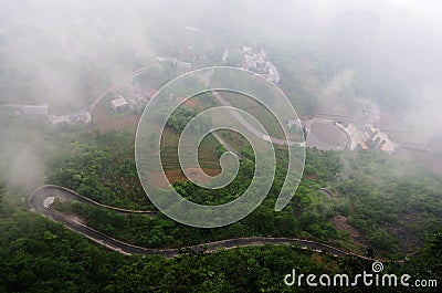 Tortuous road in the fog Stock Photo