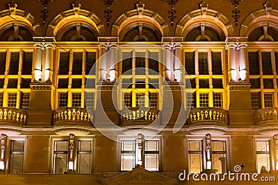 TORUN, POLAND - JANUARY 08, 2016: Night view of the windows of the Artus Court. The building was designed by Rudolph Schmidt in Editorial Stock Photo