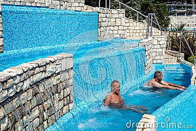 Torvaianica, Italy - July 2017: People having fun in the swimming pool in water park at Zoomarine acqua park Editorial Stock Photo