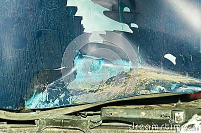 Total damage on the blue car hood with broken metal parts scratched paint and rusty dirt from cooler destroyed in crash accident c Stock Photo