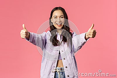 Totally agree. Portrait of cheerful young woman in denim jacket approve awesome, super cool idea, show thumbs-up and Stock Photo