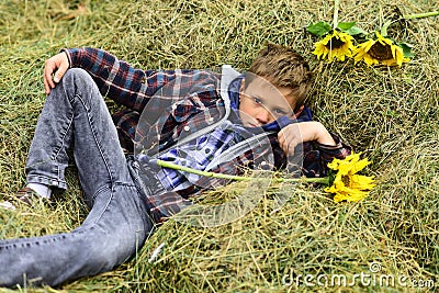 Totally carefree. Small boy relax in hayloft. Small boy in farm barn. Hayloft in countryside. Just relaxing Stock Photo