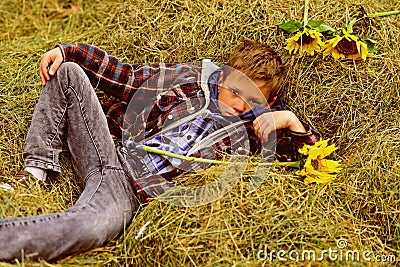 Totally carefree. Small boy relax in hayloft. Small boy in farm barn. Hayloft in countryside. Just relaxing Stock Photo