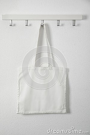 Tote bag hanging on white wall Stock Photo