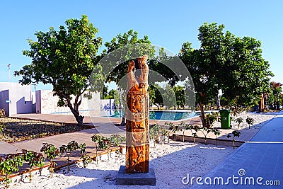 Totem statue and swimming pool Stock Photo