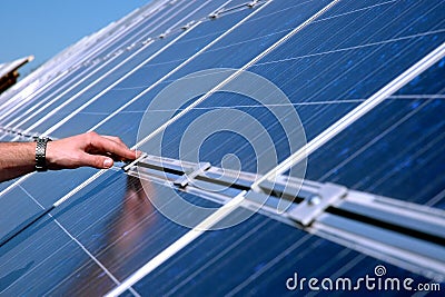 Touching a solar panel Stock Photo