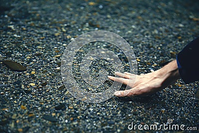 Touching the water. Hand in water. Pure water. Transparent pond. Pond in the mountains. Crystal River Stock Photo