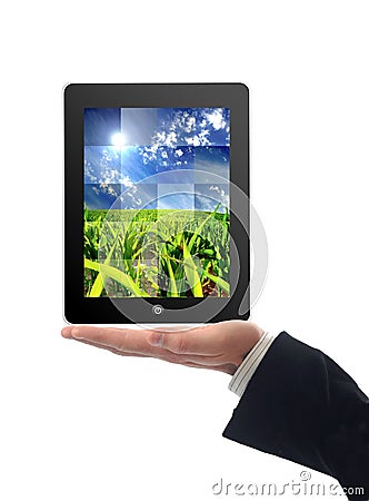 Touchscreen tablet with splitted image of field in Stock Photo