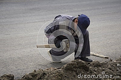 Tough worker with iron chain and sledgehammer Editorial Stock Photo