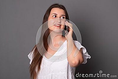 Toung woman emotionally talking on a mobile phone. Happy young woman Stock Photo