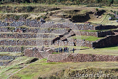 Tour group exploring Inca Terraces Editorial Stock Photo