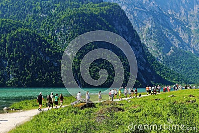 Hikers in scenic landscape at mountain lake holiday activities Editorial Stock Photo