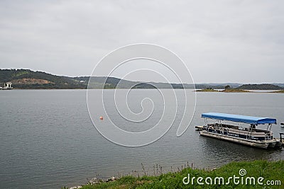 Tourism Boat on a marina pier of Alqueva Dam reservoir, in Portugal Editorial Stock Photo