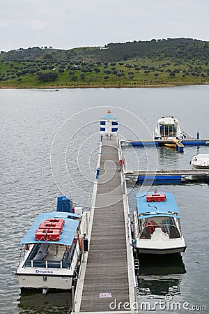 Tourism Boats on a marina pier of Alqueva Dam reservoir, in Portugal Editorial Stock Photo