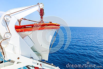 Tourism ship. Detail of the lifeboat, in the open sea, deep blue color. Stock Photo