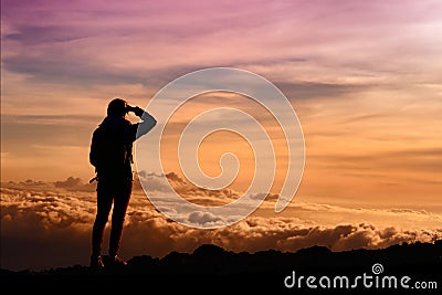 Tourist admiring breathtaking sunset views from the Mauna Kea, a dormant volcano on the island of Hawaii Stock Photo