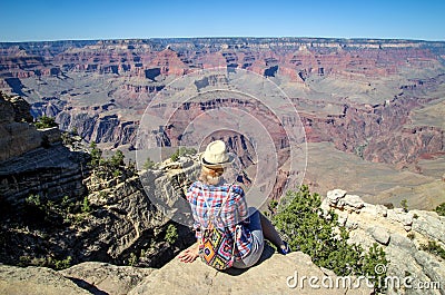 Tourist admiring multicoloured rocks with dozens of layers in Grand Canyon Stock Photo