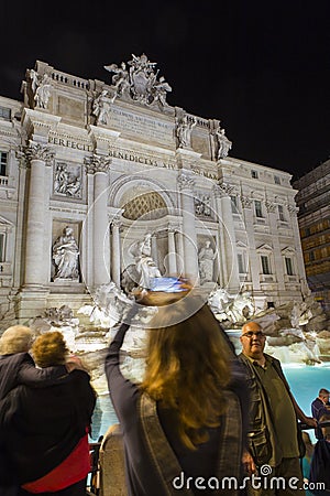 Tourist admiring the Trevi Fountain from Rome Stock Photo