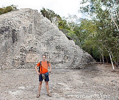 The tourist against pyramid ruins Mexico. Archeologic zone Kabah. Stock Photo