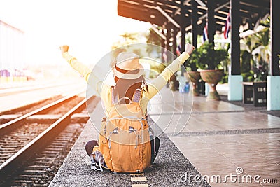 Tourist asian lifestyle women wearing backpack holding map, traveler siting for waiting a train, so happy and relax Stock Photo