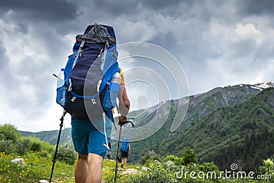 Tourist with backpack hike on mountain trek. Hiking in Svaneti, Georgia. Trekking in mountains Stock Photo