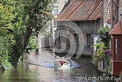 Tourist boat in bruges canal on sunny summer day Editorial Stock Photo