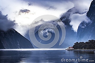 Tourist boat cruising in milford sound fjordland national park Stock Photo