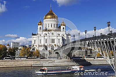 Tourist boat floats on the Moscow river on the background of the temple of Christ the Savior, Moscow Editorial Stock Photo