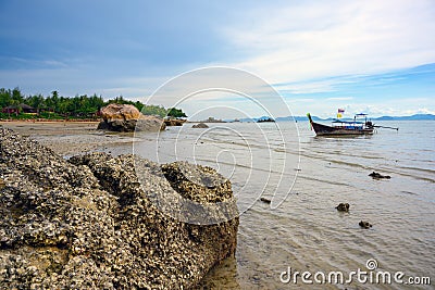 A tourist boat is moored in the water by the beach at Tup Kaek, Krabi, Thailand Stock Photo